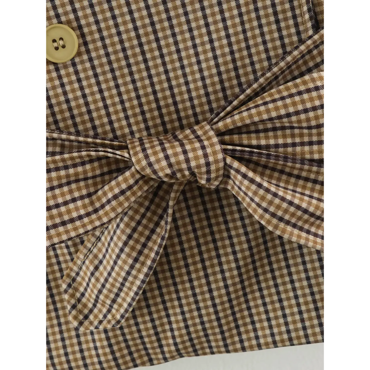 Close-up of gingham belt bow detail