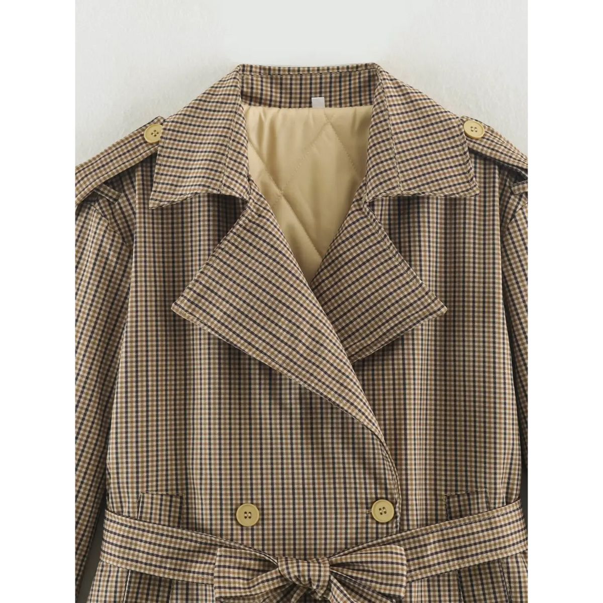 Close-up of gingham collar and quilted lining