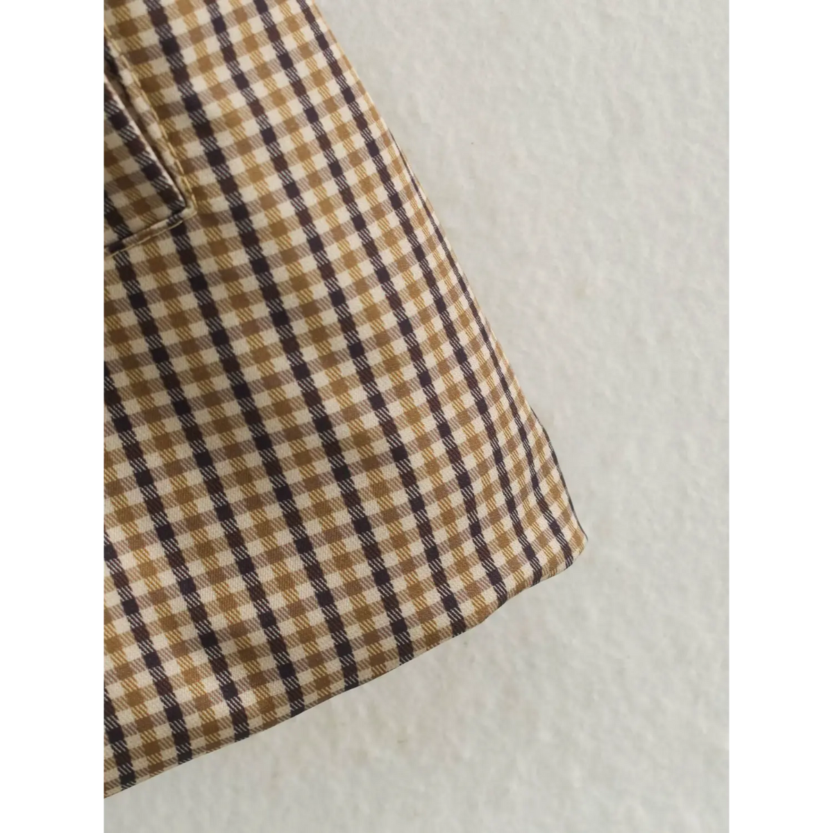 Close-up of gingham jacket hem