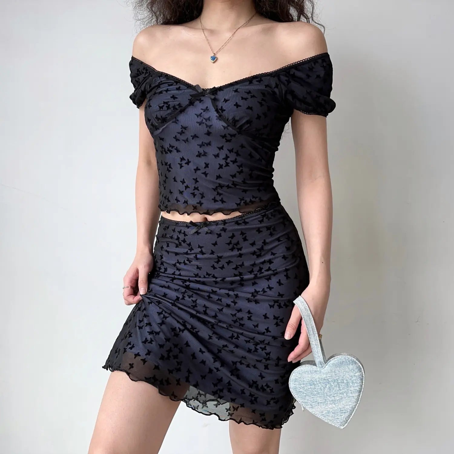  Full body studio shot black mesh 2 piece matching set, off shoulder puff sleeve cropped top + ruched mini skirt allover velvet butterfly print