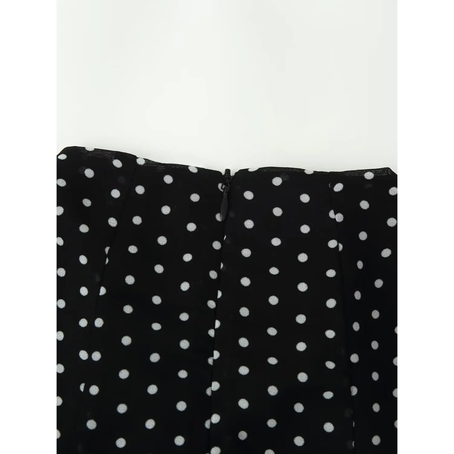 Closeup shot, black chiffon polka dot dress with invisible back zipper detail