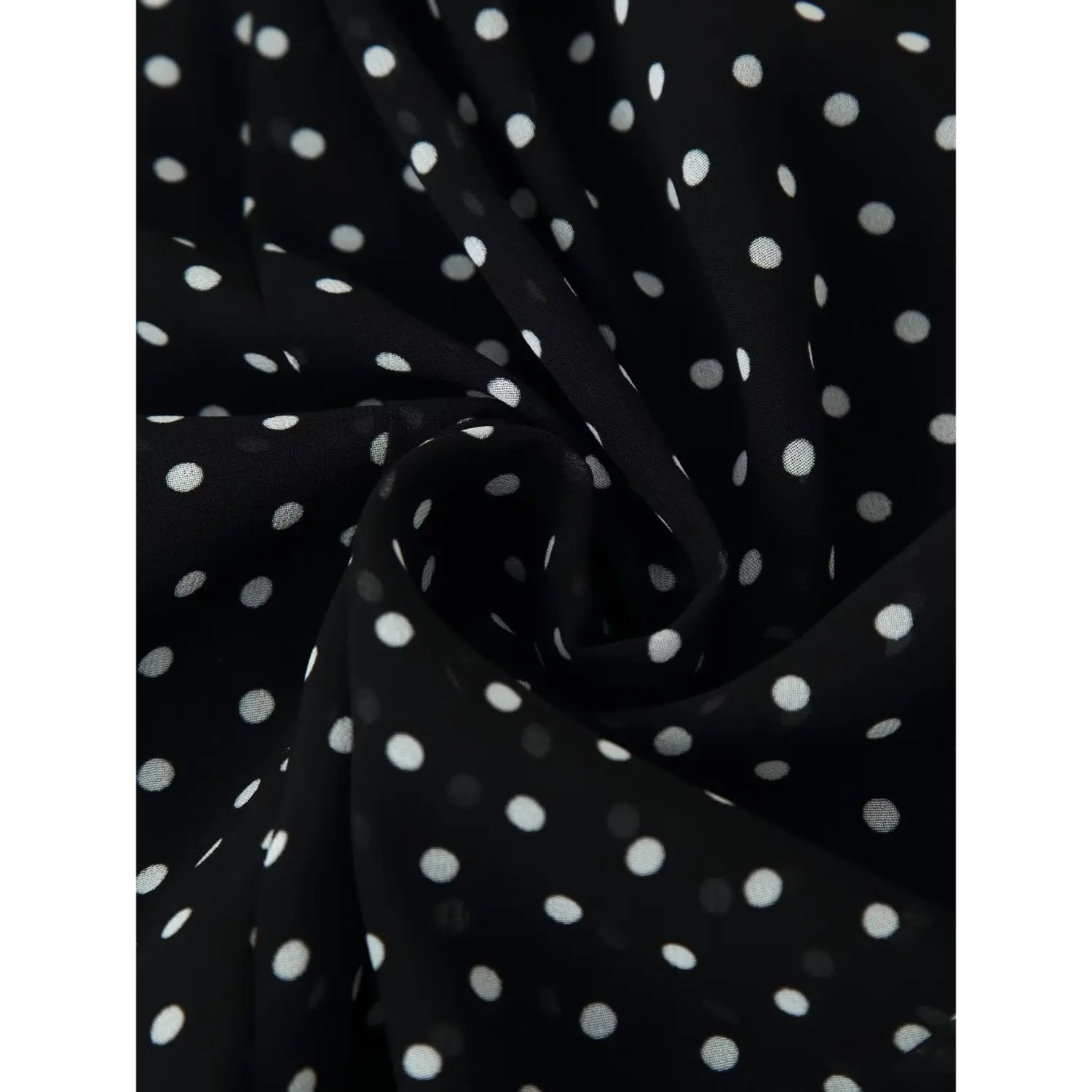 Closeup shot, black chiffon fabric with white polka dot print texture and drape detail