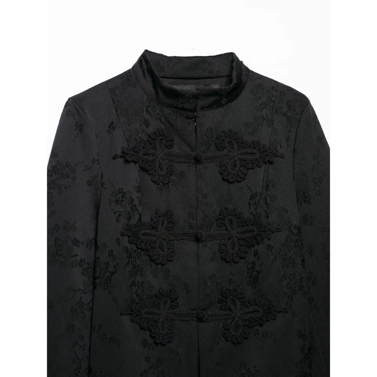 Close‑up front chest view, black cropped jacket with ornate chinese frog knot buttons, mandarin collar, floral jacquard