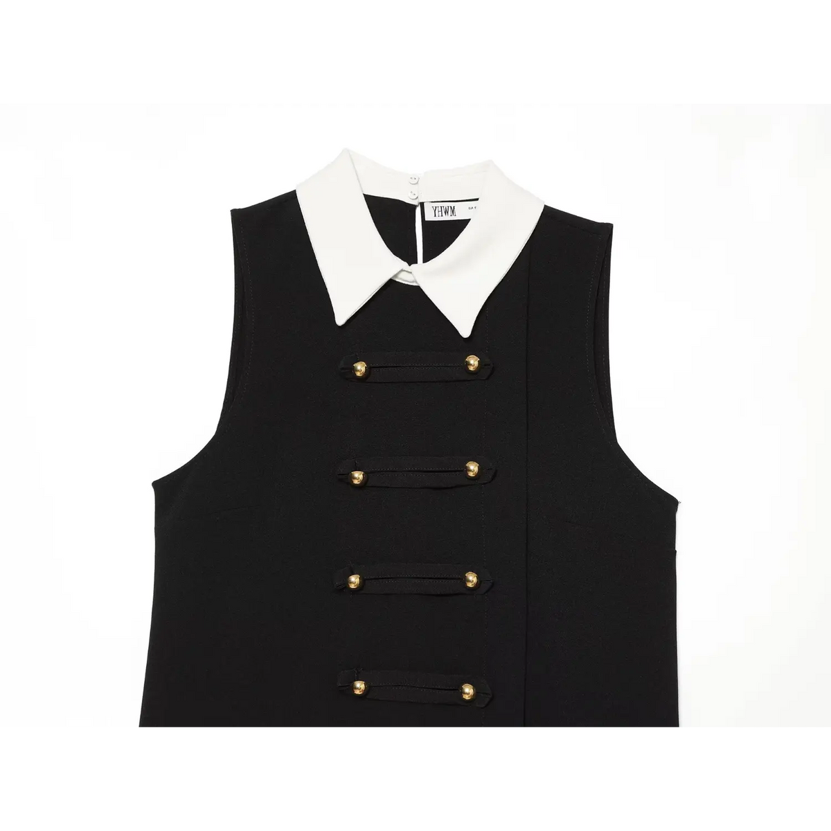 Close-up of white pointed collar and gold button decorative tabs