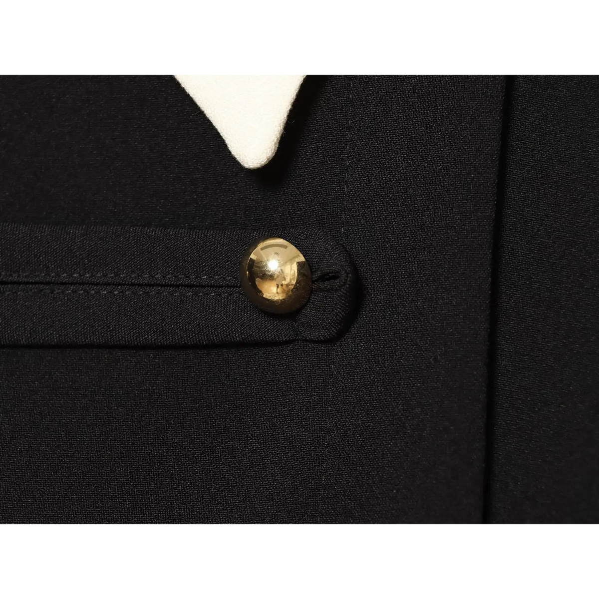 Close-up of polished gold ball button