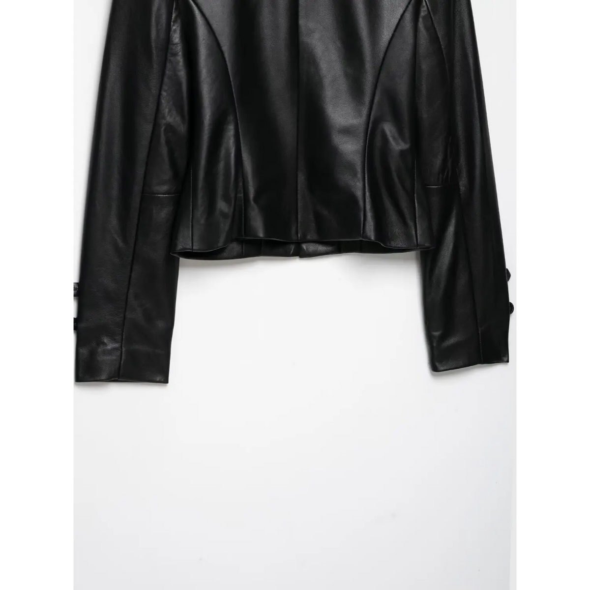 Back hem view of black cropped leather jacket, fitted silhouette and long sleeves