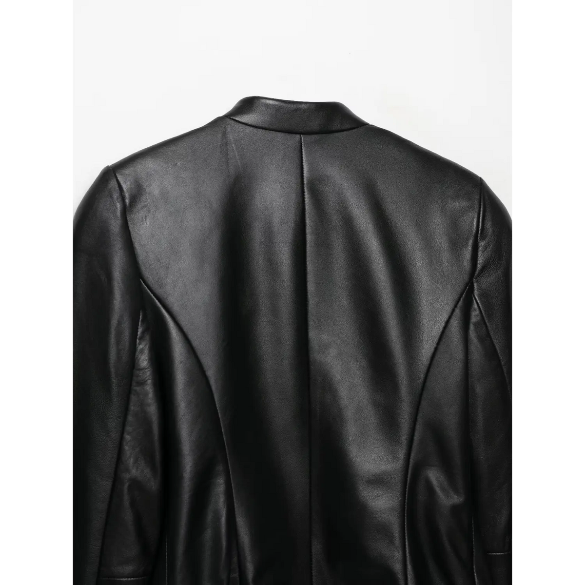 Back shoulder view of women black cropped leather jacket, tailored curved seam design