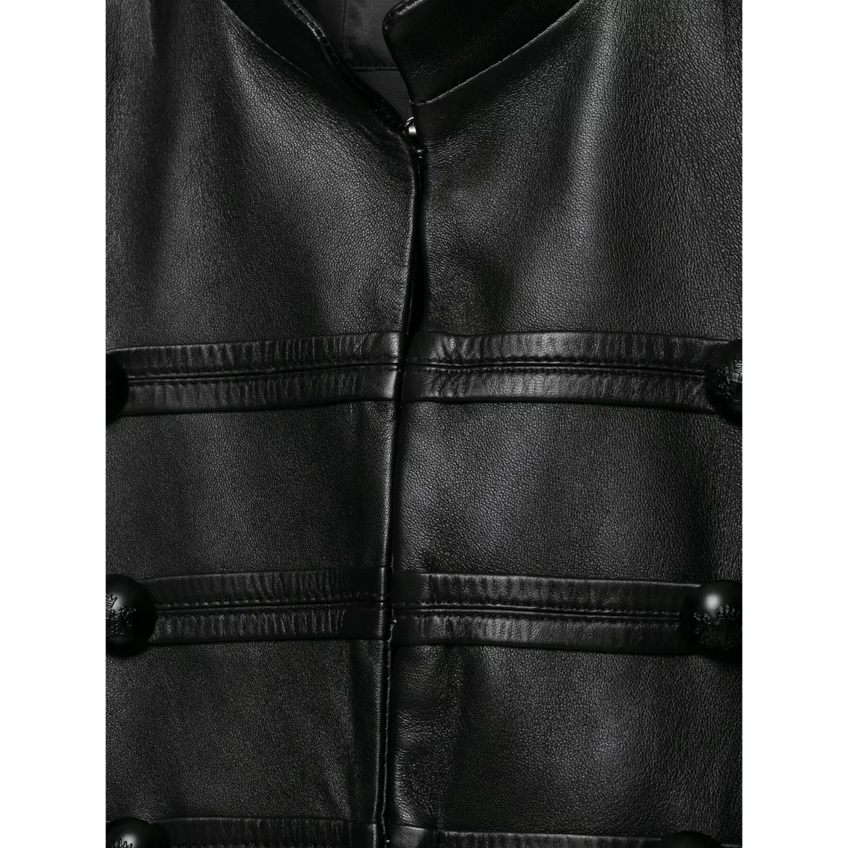 Close up of front fabric and decorative double row buttons of women black cropped leather jacket, smooth leather grain