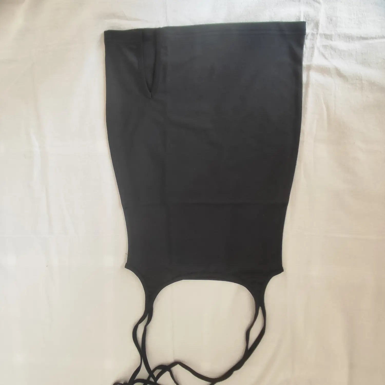 Flat lay full back view black tie suspender mini skirt showing waist cutout silhouette