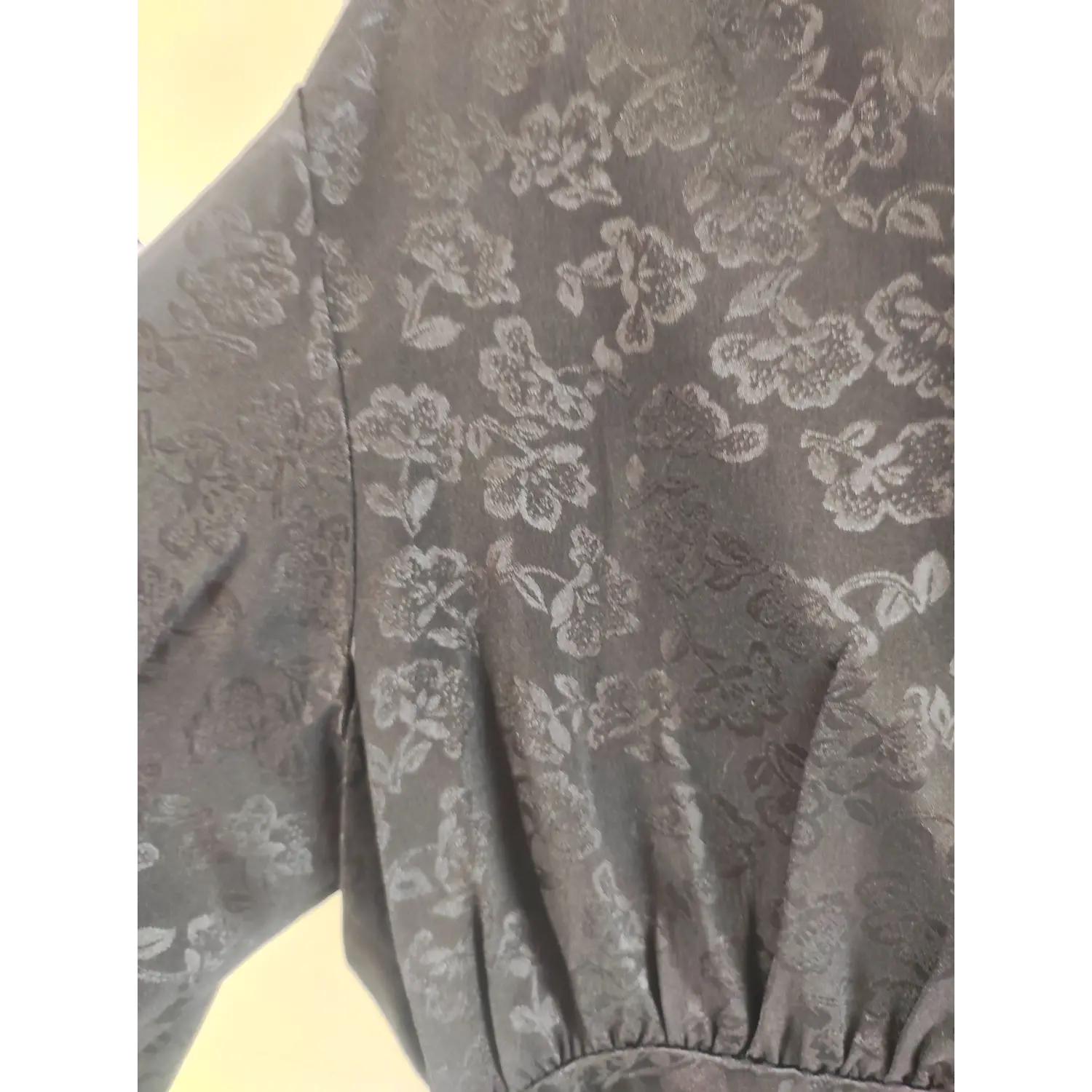 Black allover subtle floral jacquard fabric, bust ruched long sleeve dress close-up | Detail