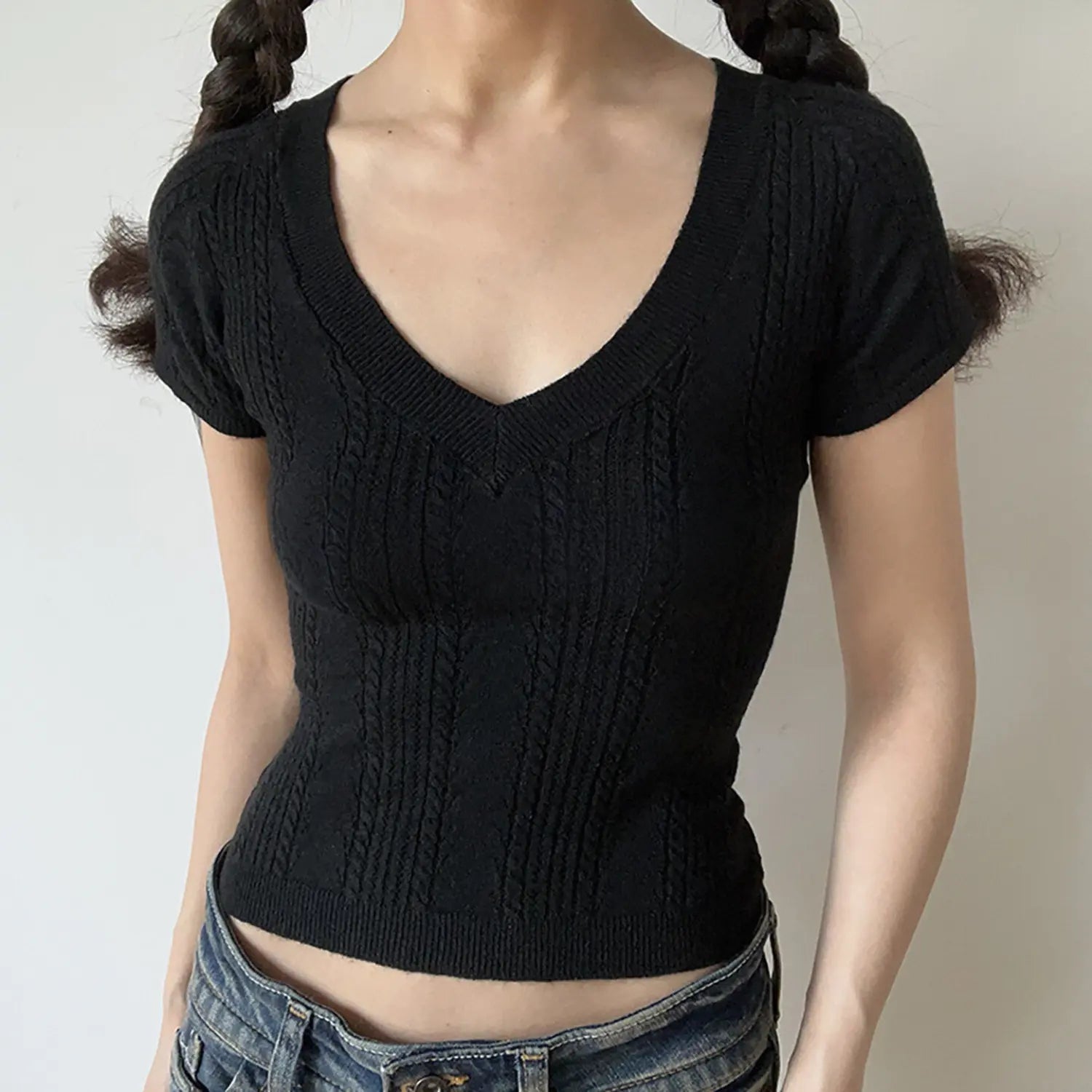 Black deep v cable twist knit short sleeve cropped top, fitted rib bottom lightweight women basic knit tee studio front view