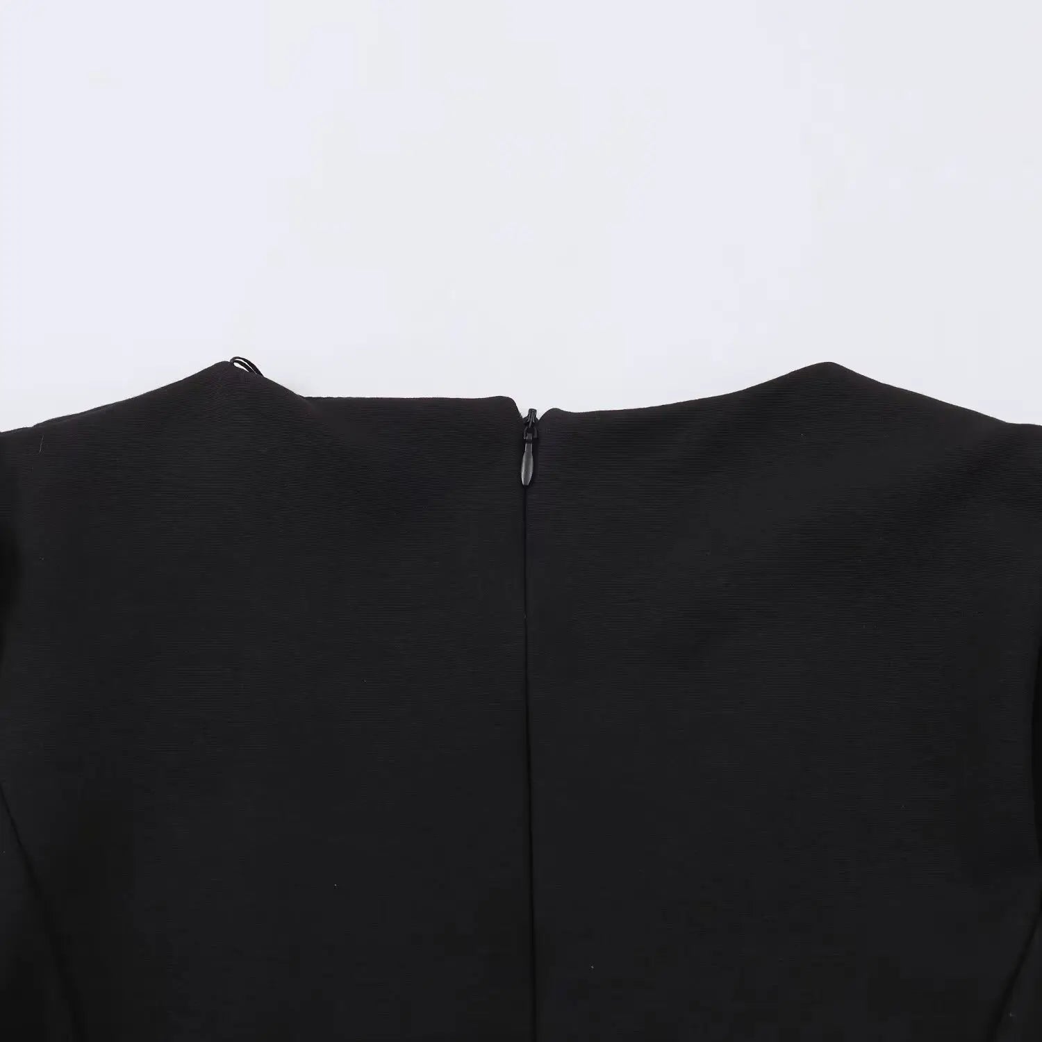Back neckline full shot, invisible zipper at center back of black mini dress