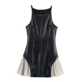 Full front flat view of a black faux-leather mini dress with a pleated beige skirt, thin straps, and structured bodice