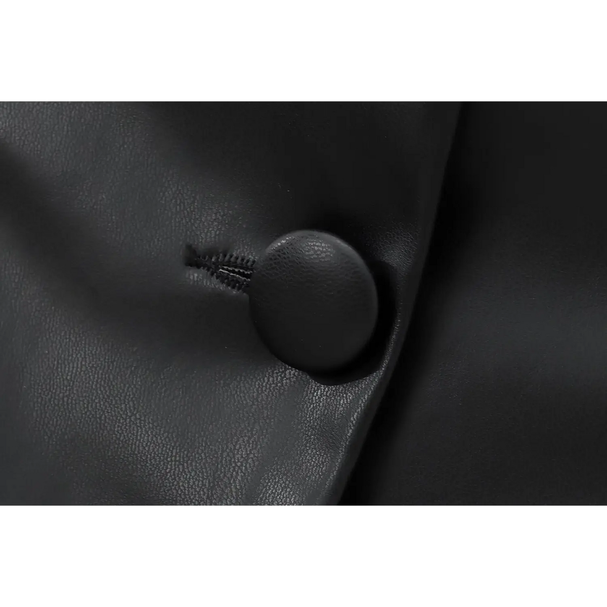 Close-up of covered button and topstitch detail