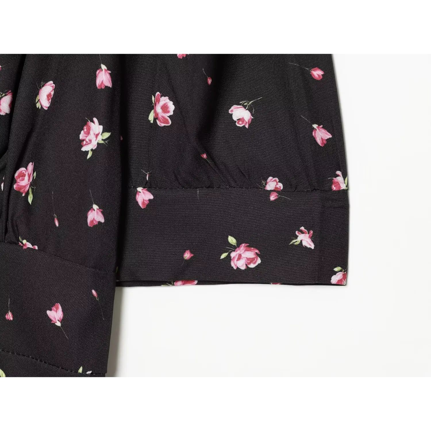 Close-up of elbow sleeve cuff for black base pink small floral mini dress