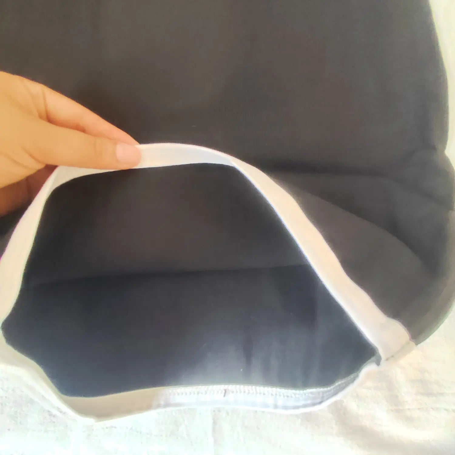Inside view of dress hem showing fabric thickness and white finished edge trim