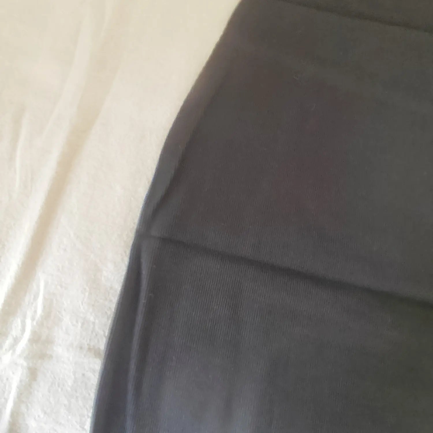 Extreme close‑up of vertical ribbed knit fabric texture of black halter mini dress