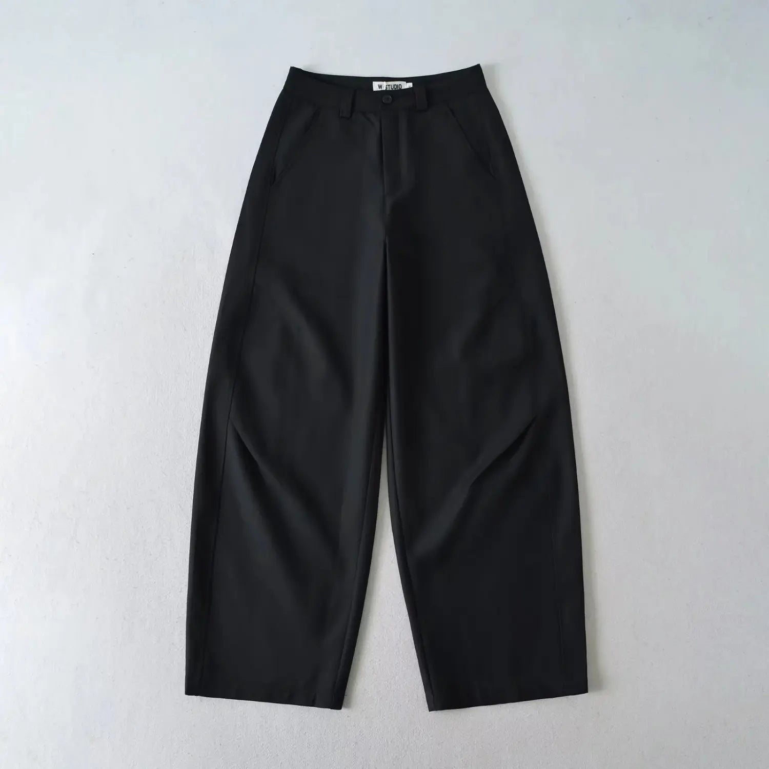 Single black high waist wide leg tailored suit trousers front view flat lay on white background, relaxed fit casual dress pants