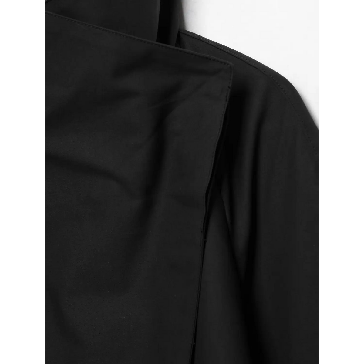 Macro detail view of black short jacket diagonal wrap front stitching and fabric texture