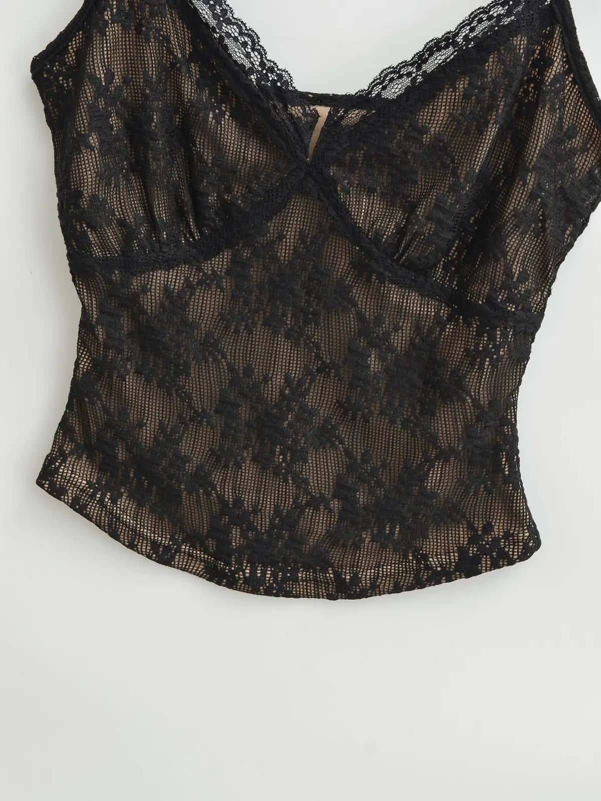 Close-up of the lace texture and fitted bodice on the black cami top