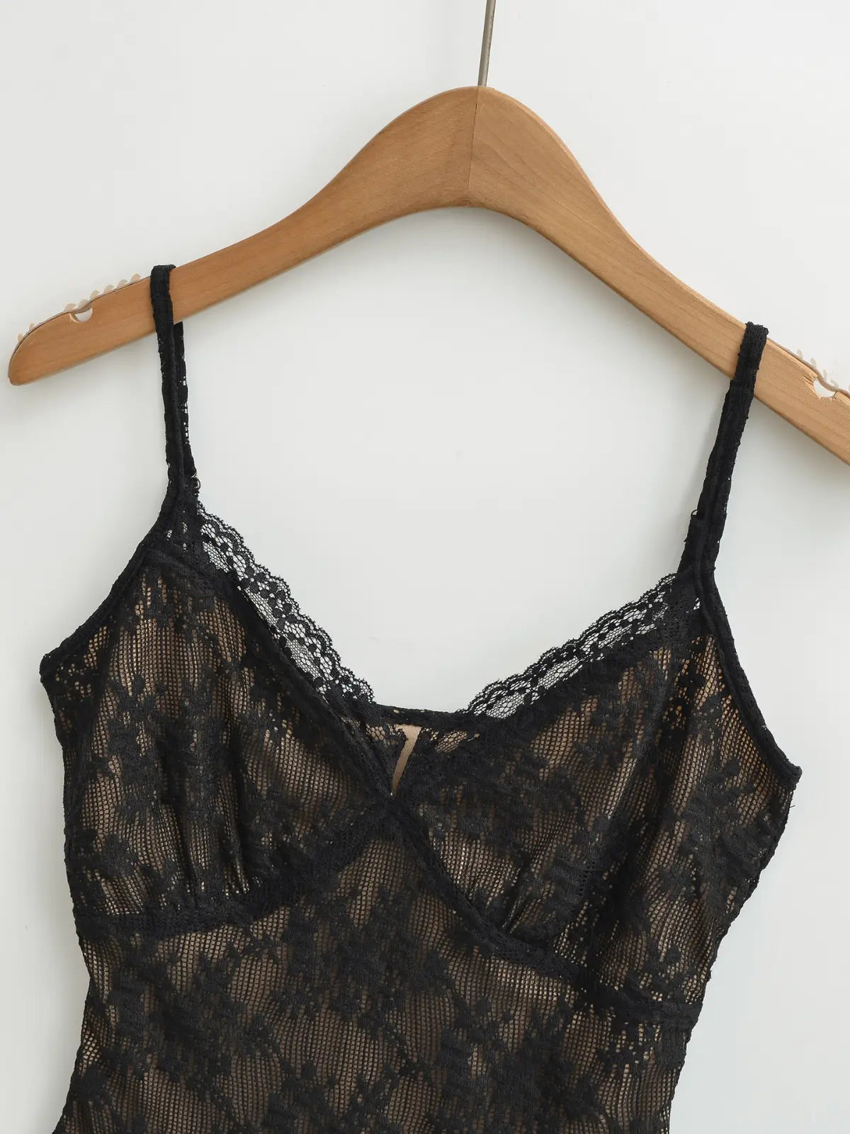 Black lace cami top, clean front view on wooden hanger