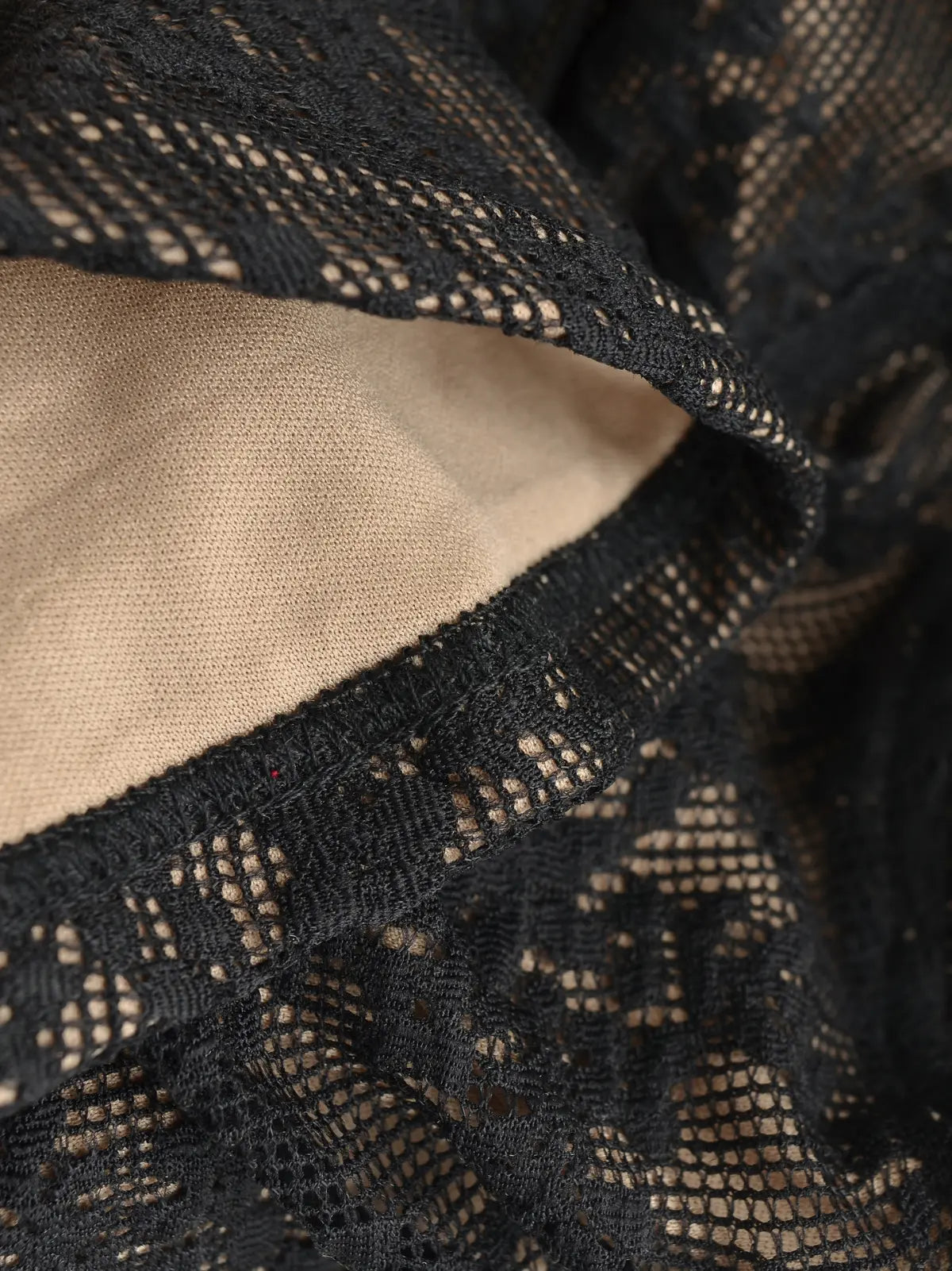 Close-up of the inner lining and sheer lace texture on the black cami top
