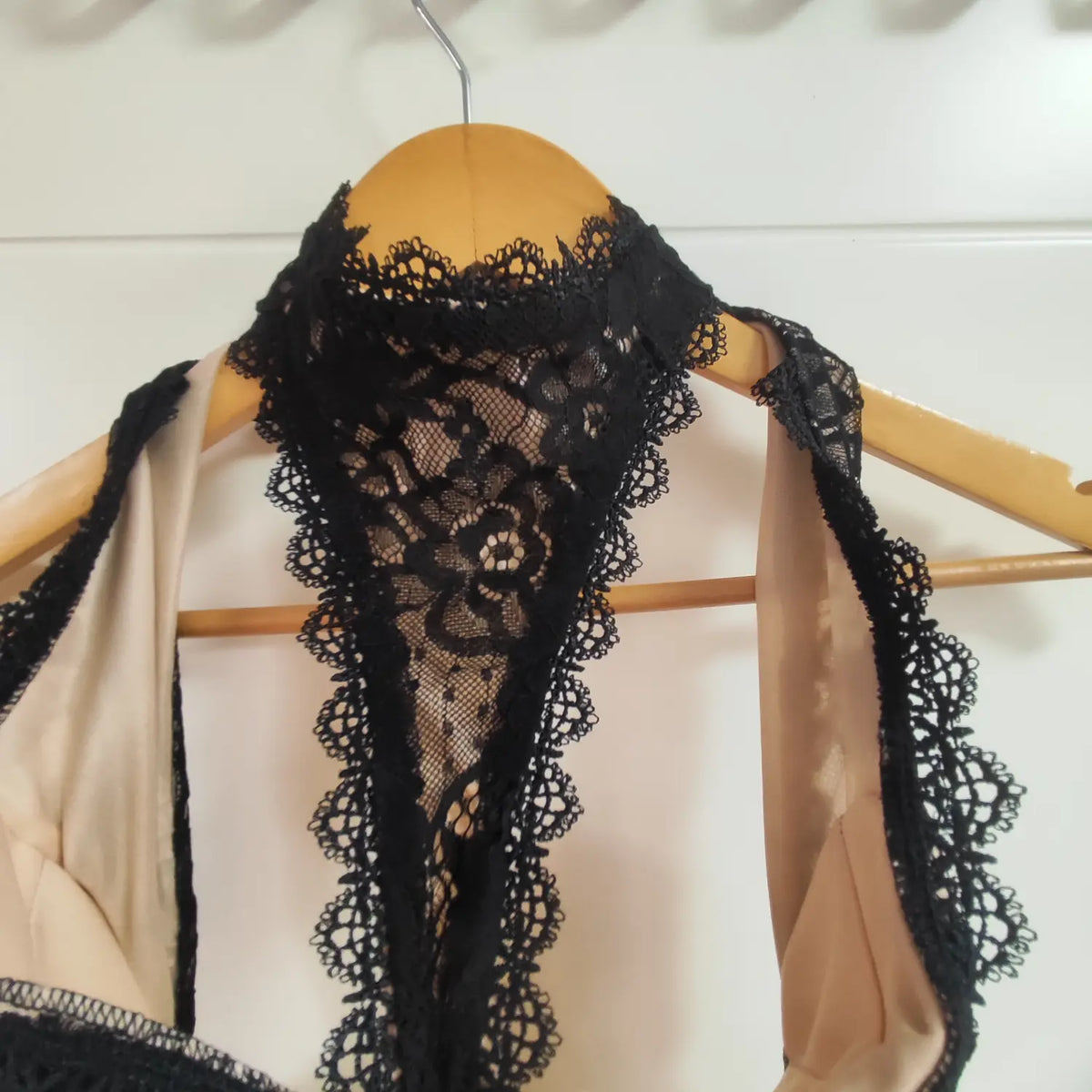 Close‑up of black scalloped lace halter neck trim on maxi dress