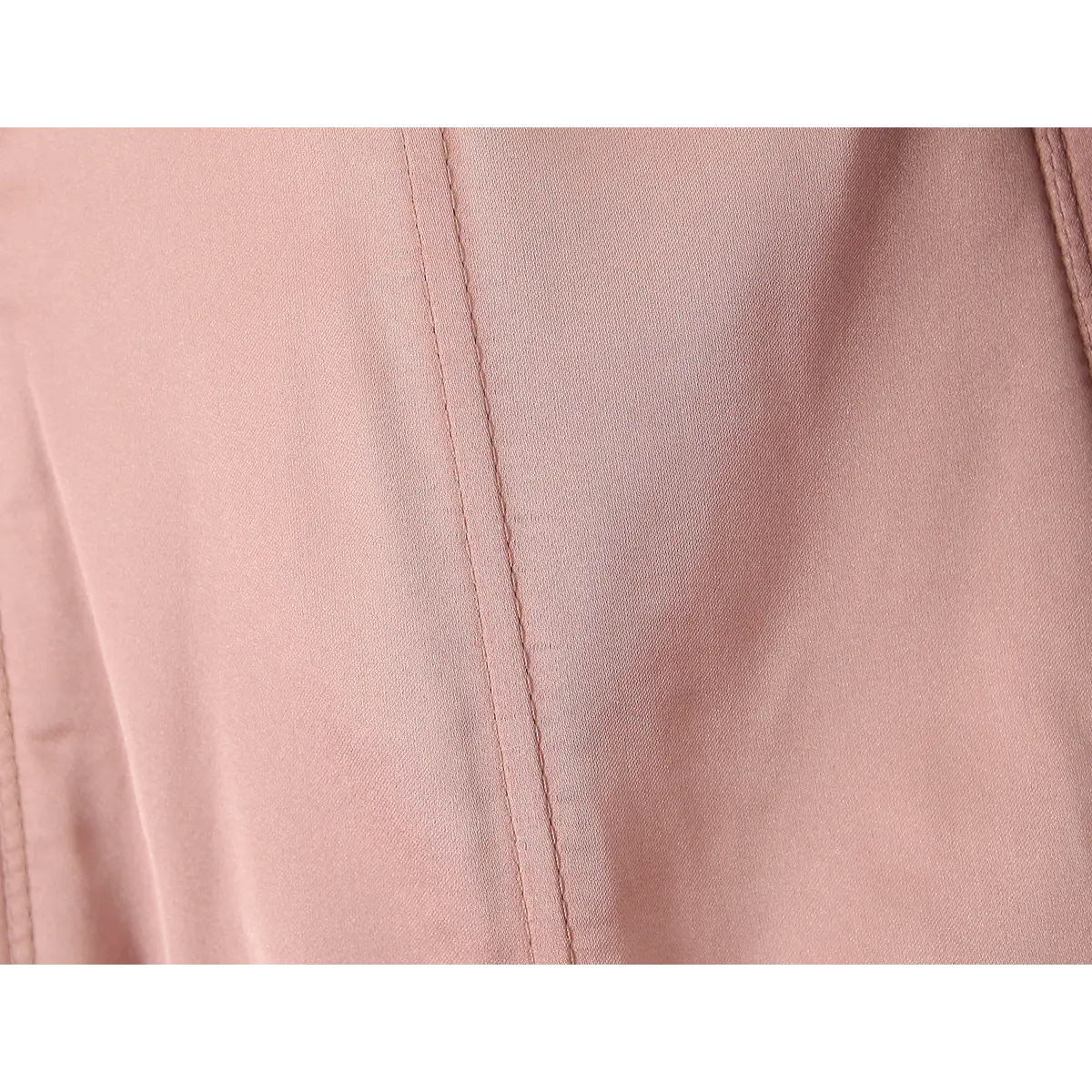 Close-up of the smooth rose-pink lining and internal boning of the bustier.