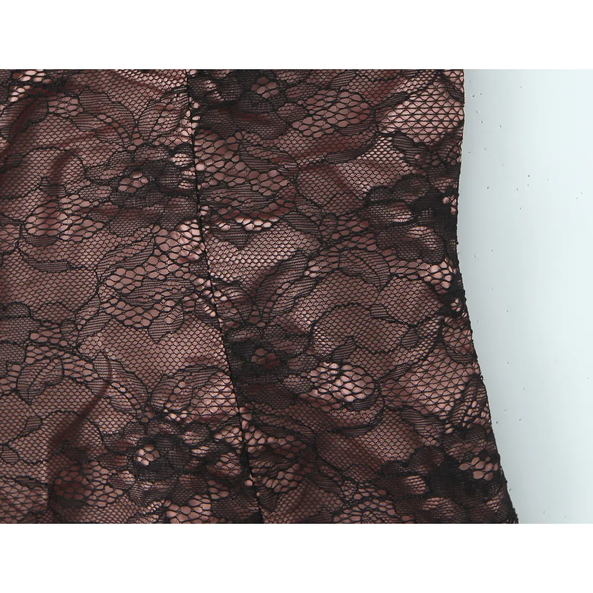 Close-up of the floral lace pattern and structured side panel on the bustier.