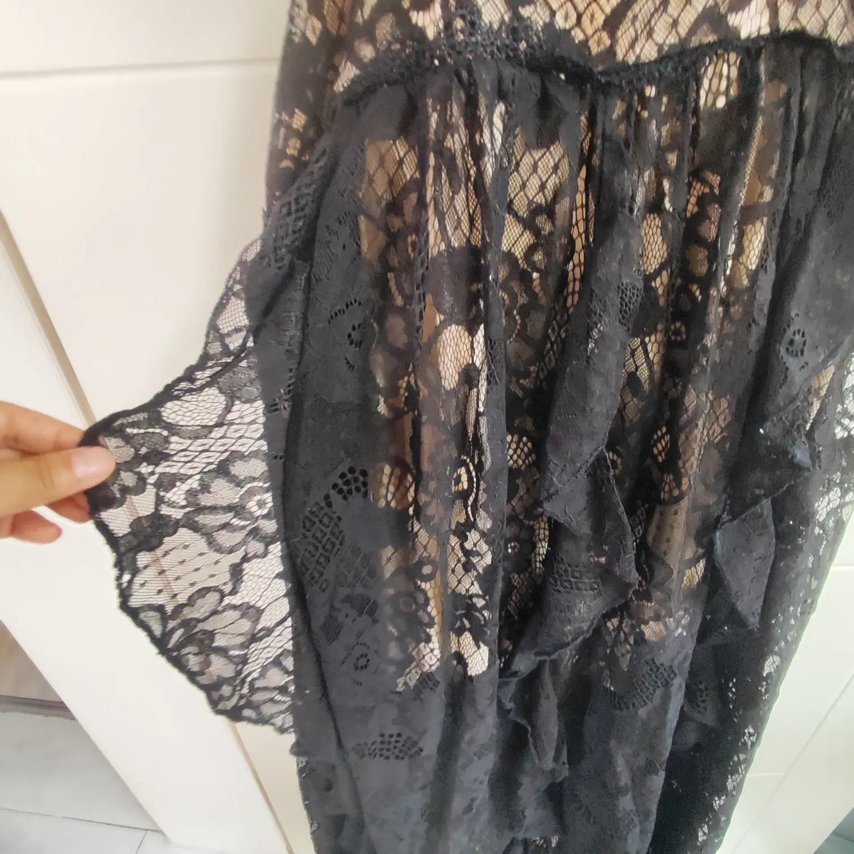 Close‑up of ruffled flowing black lace skirt fabric