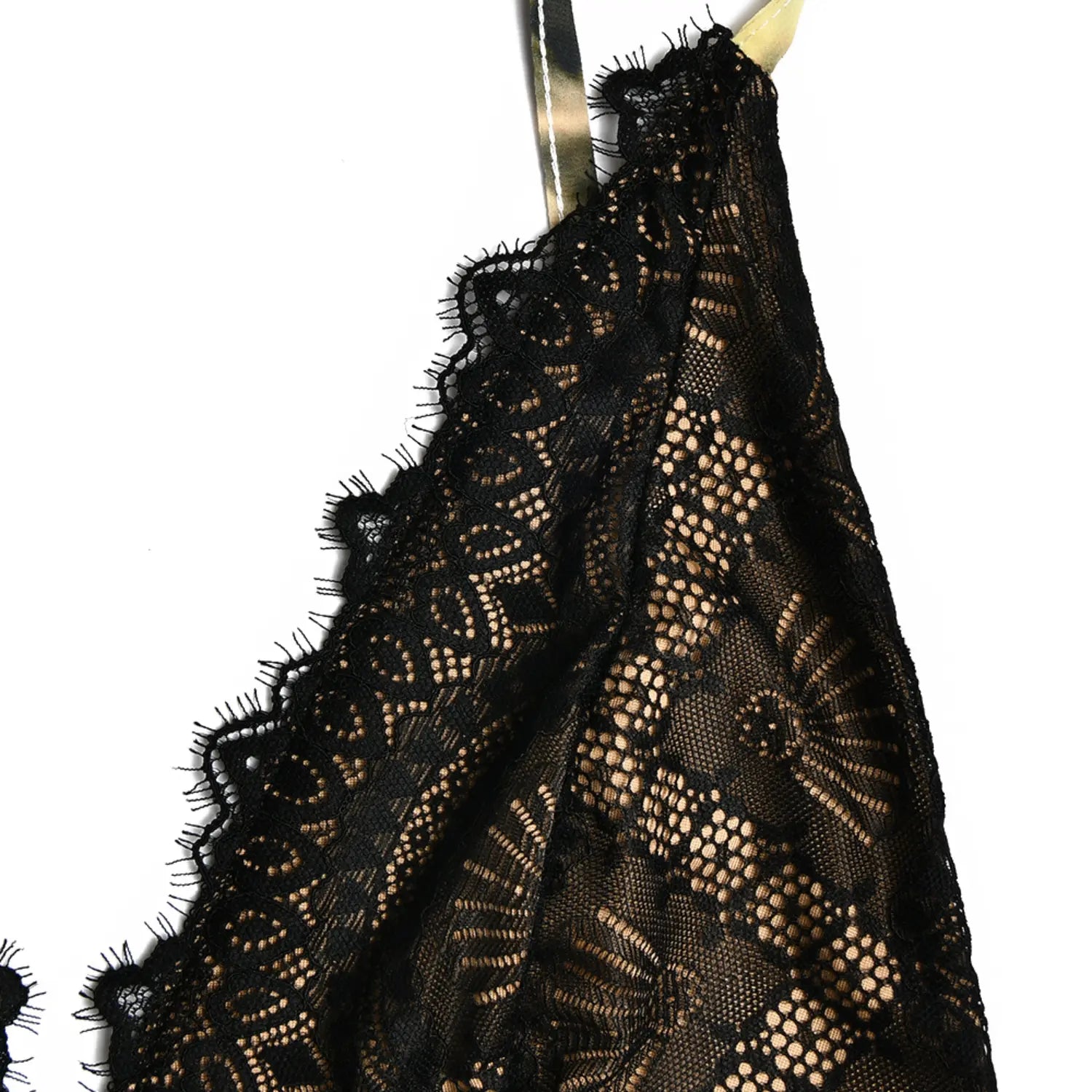 Texture closeup of vintage black eyelash scalloped lace trim on cami dress