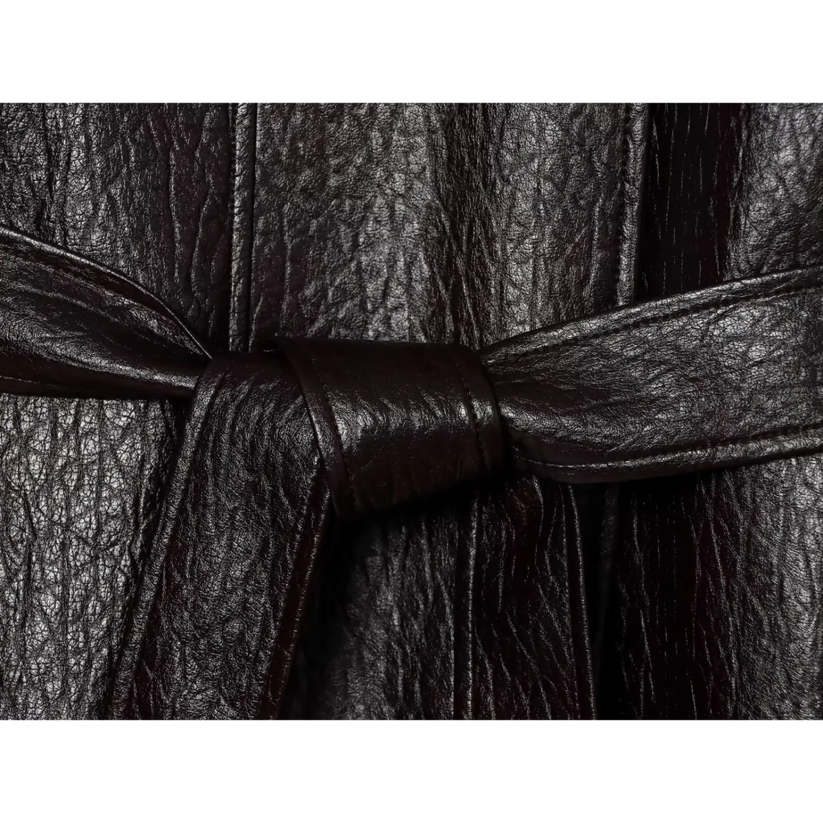 Close-up of leather belt tied in knot on textured black jacket