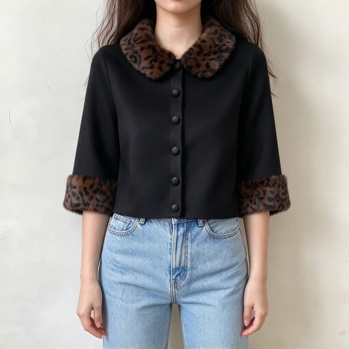 Model wearing black leopard fur collar cuff button front cropped cardigan with jeans, front view