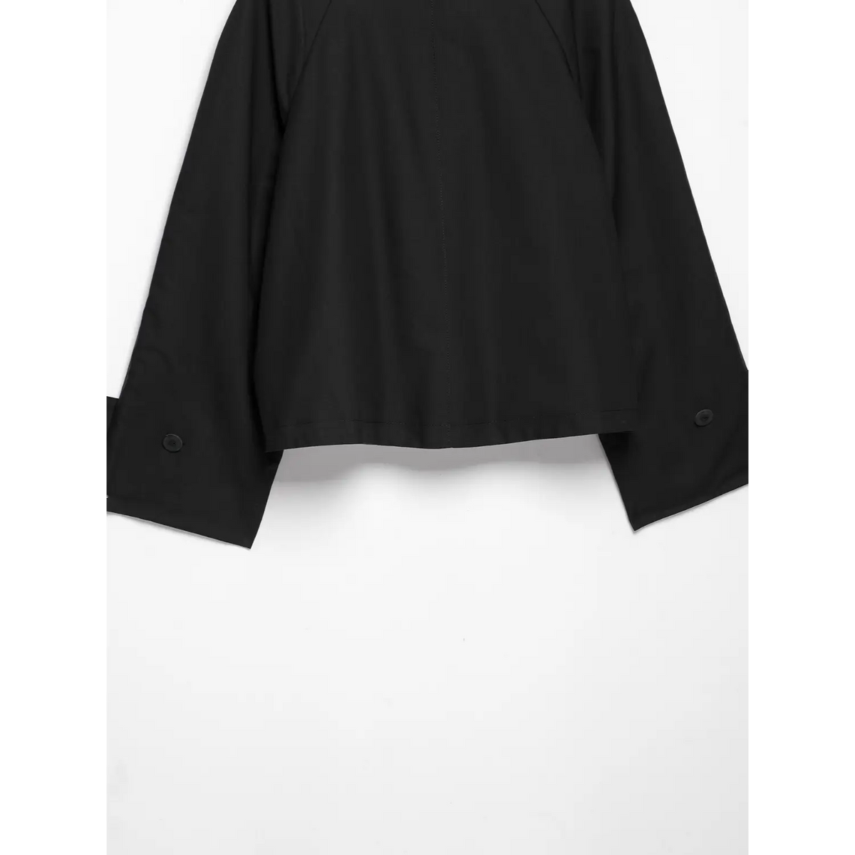 Full back flat shot of black short jacket, raglan seams, relaxed cropped hemline