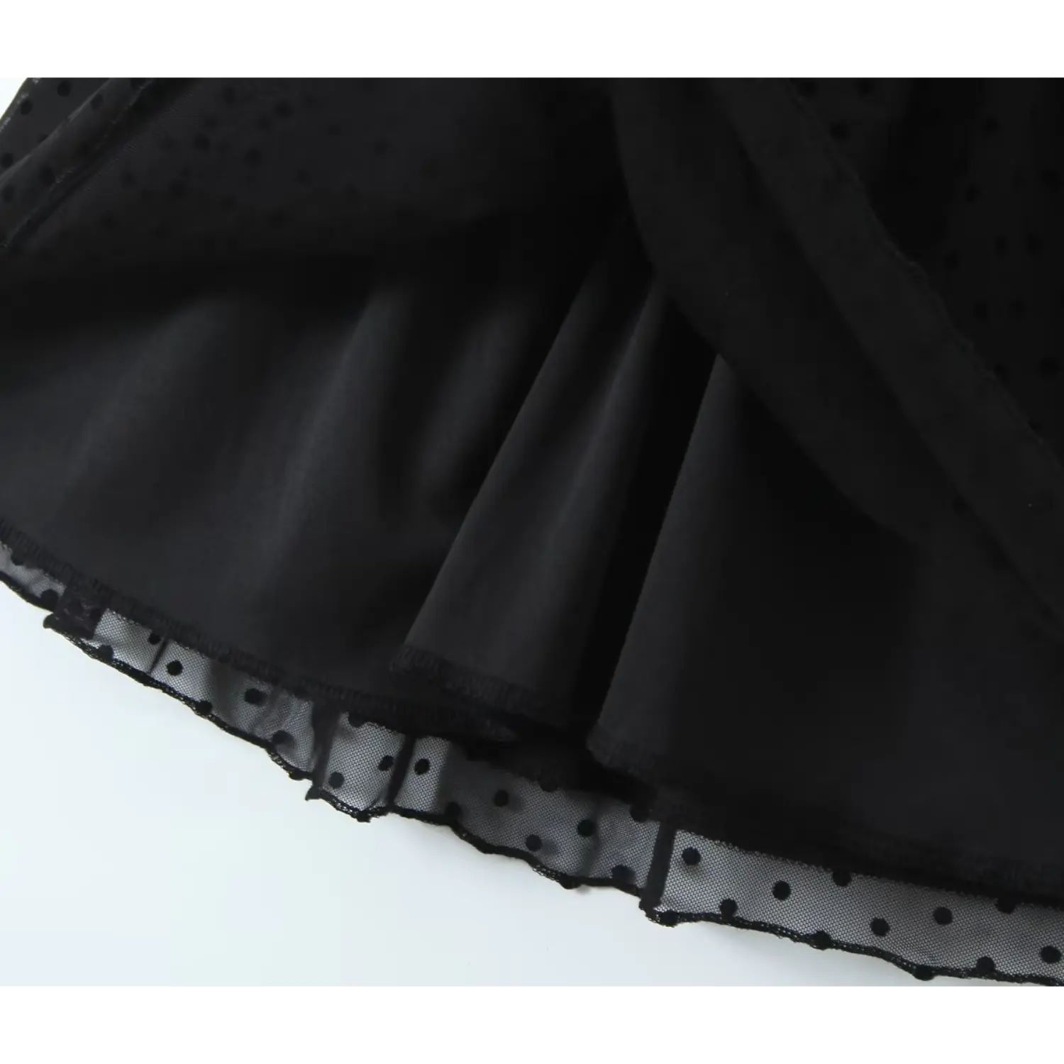 Inside view of black polka dot mesh dress, full inner lining and scalloped hem detail
