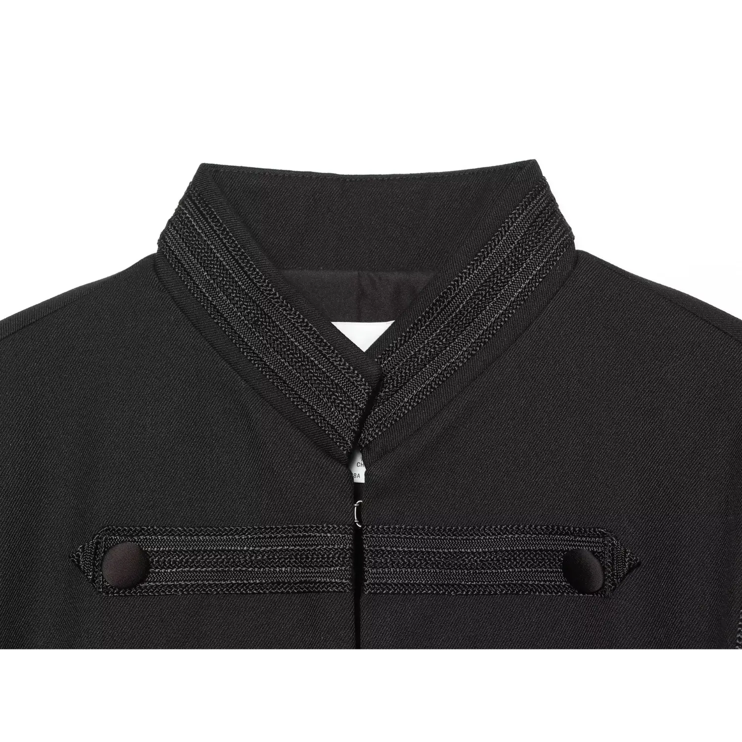 Macro close‑up of stand collar with braided embroidered trim on black cropped military jacket