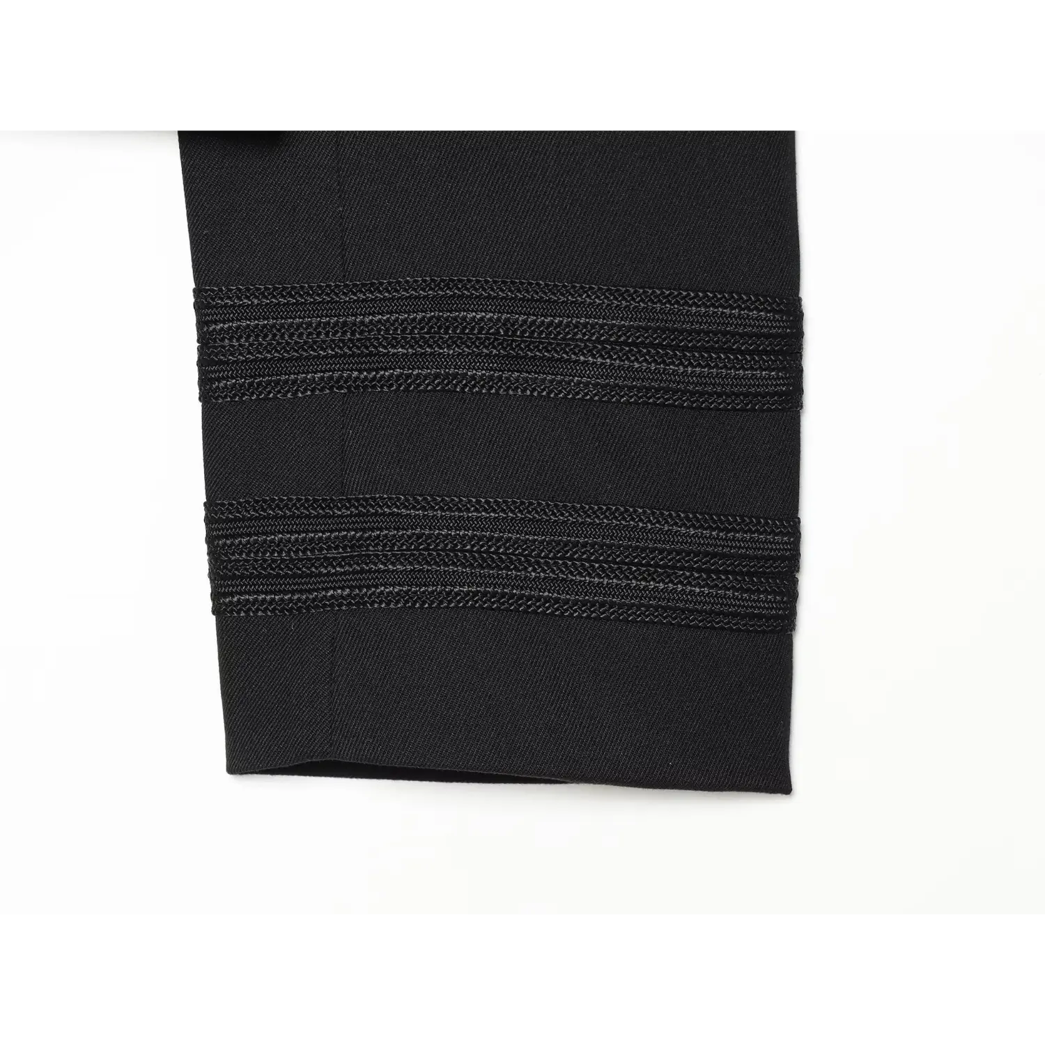 Close‑up of long sleeve cuff with multi‑row braided embroidered trim for black cropped military jacket