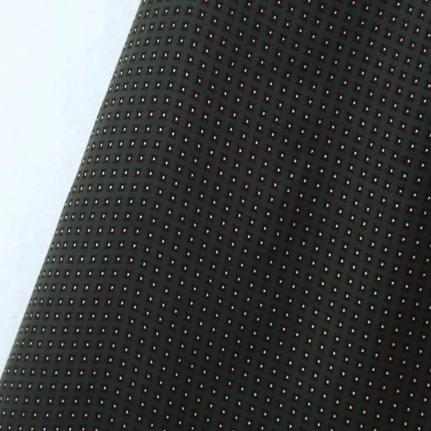 Flat fabric shot of reverse side black base with tiny light dot pattern