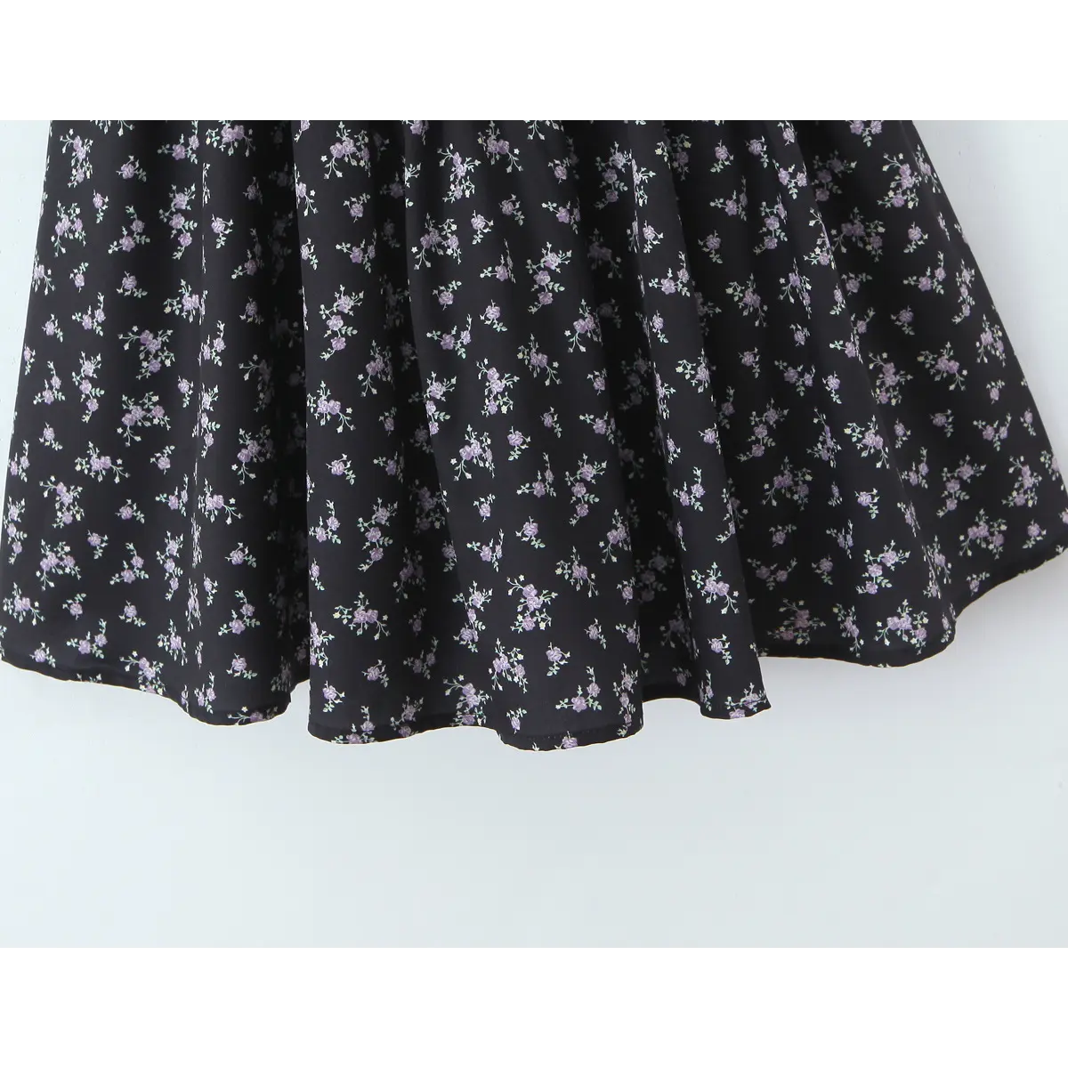 Close view of black purple floral gathered flare skirt woven fabric