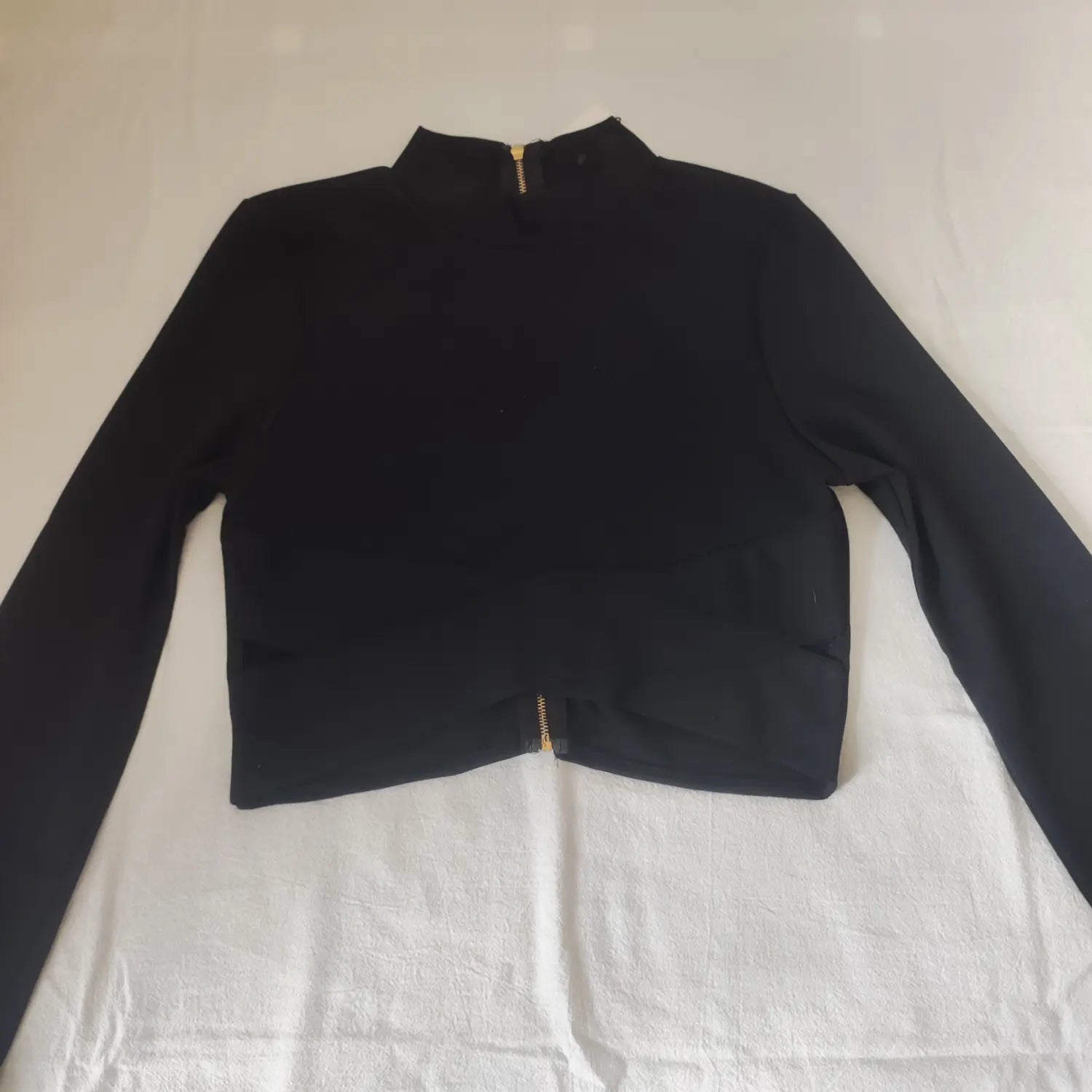 Flat lay front black ribbed long sleeve cropped top crossover wrap design side cutouts