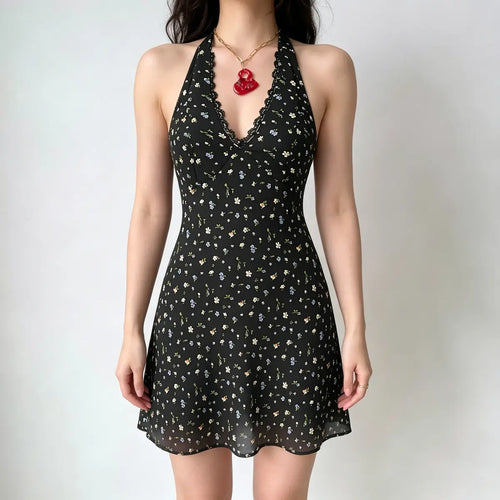 Model wearing a black halter-neck mini dress with a multi-color floral print, lace trim at the neckline, and a deep V-neck.
