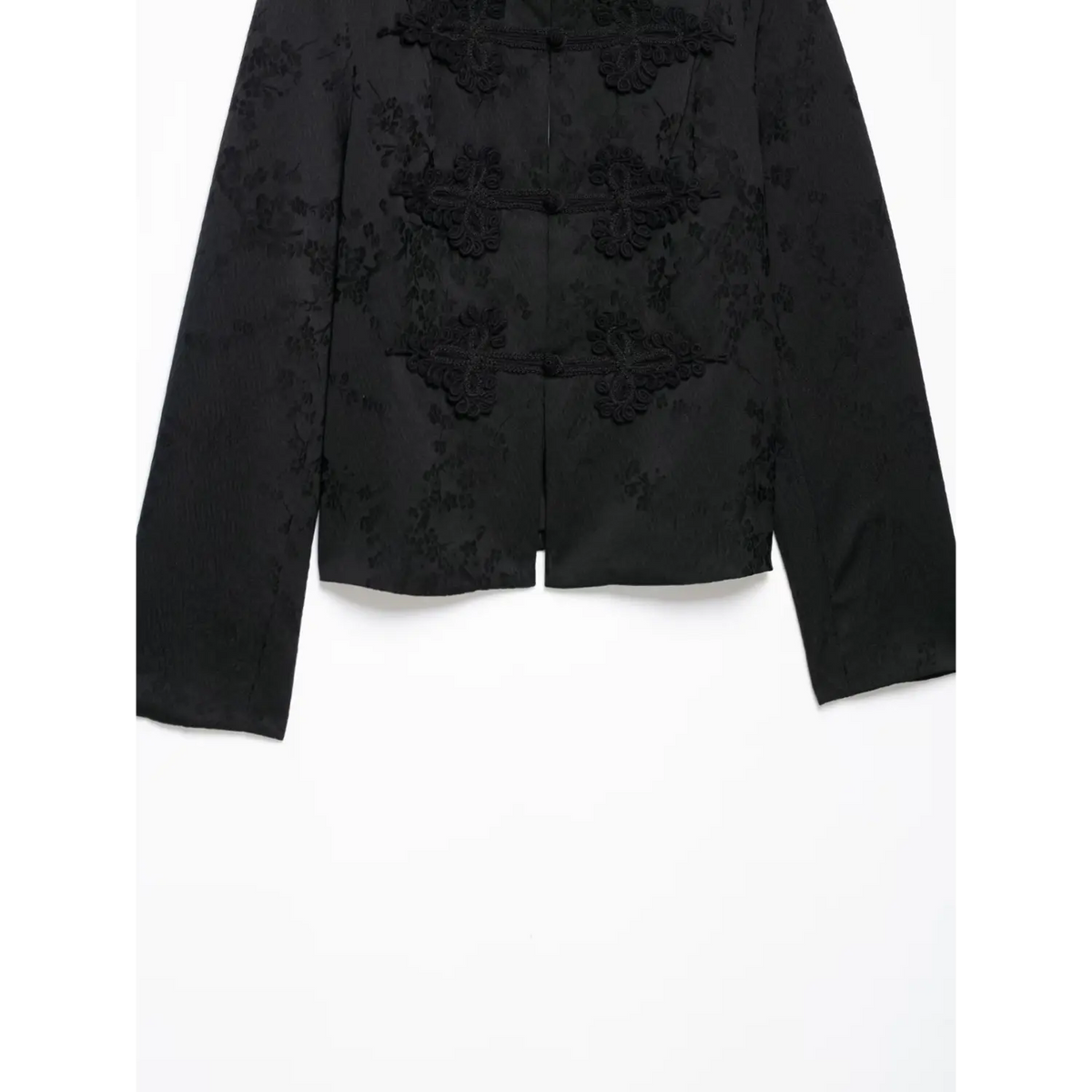 Lower front partial shot of black new chinese cropped jacket, decorative frog buttons, jacquard floral pattern, long sleeves