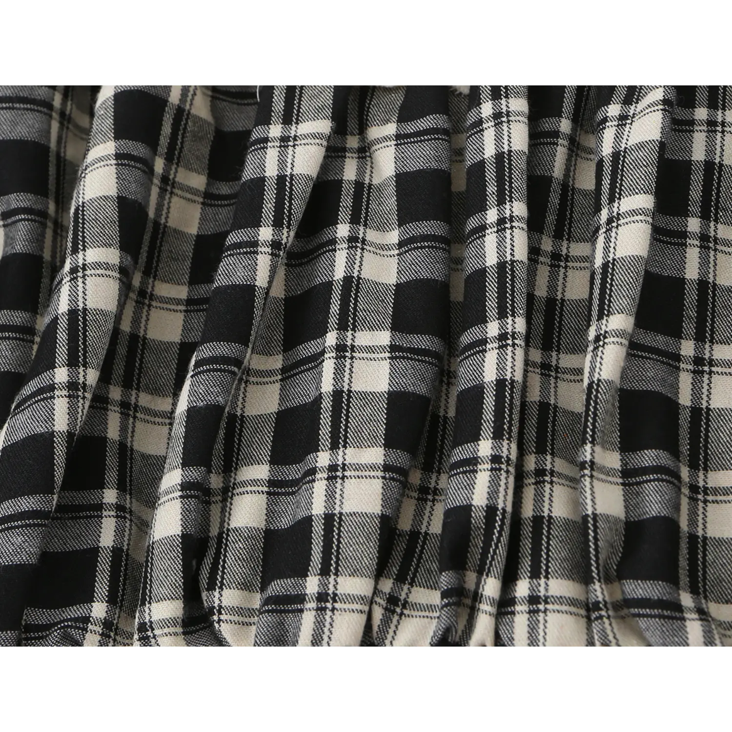 Macro texture shot lightweight soft black cream check plaid woven fabric, natural drape wrinkled fold detail for casual cropped top