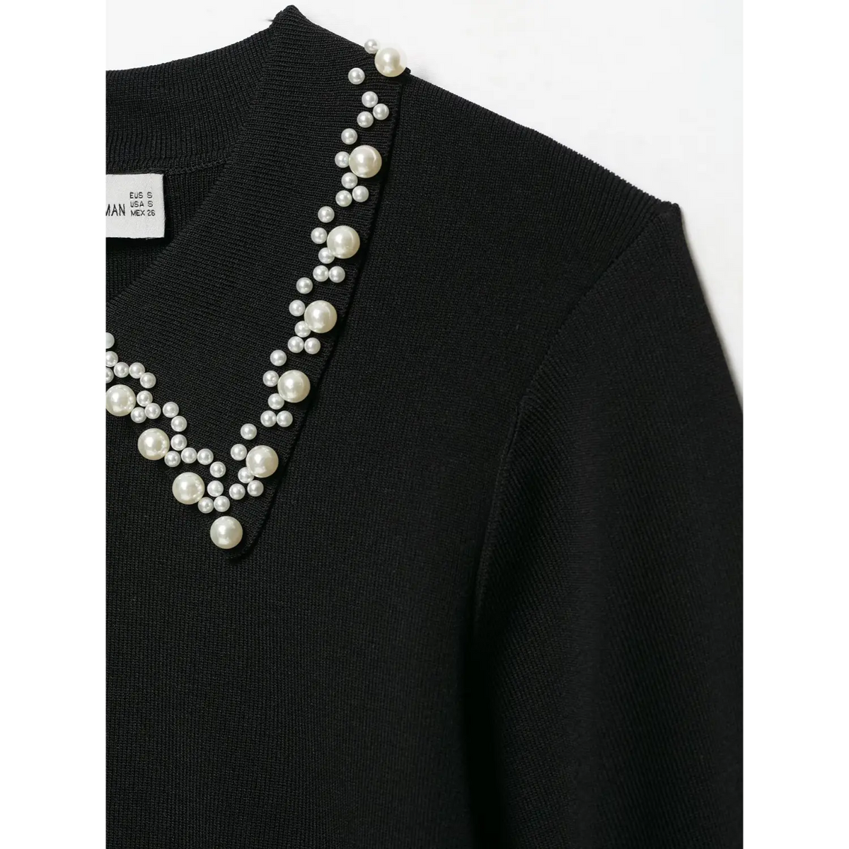 Close-up of pearl collar and shoulder seam