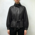 Model wearing black pebbled leather look jacket with stand collar and belted waist