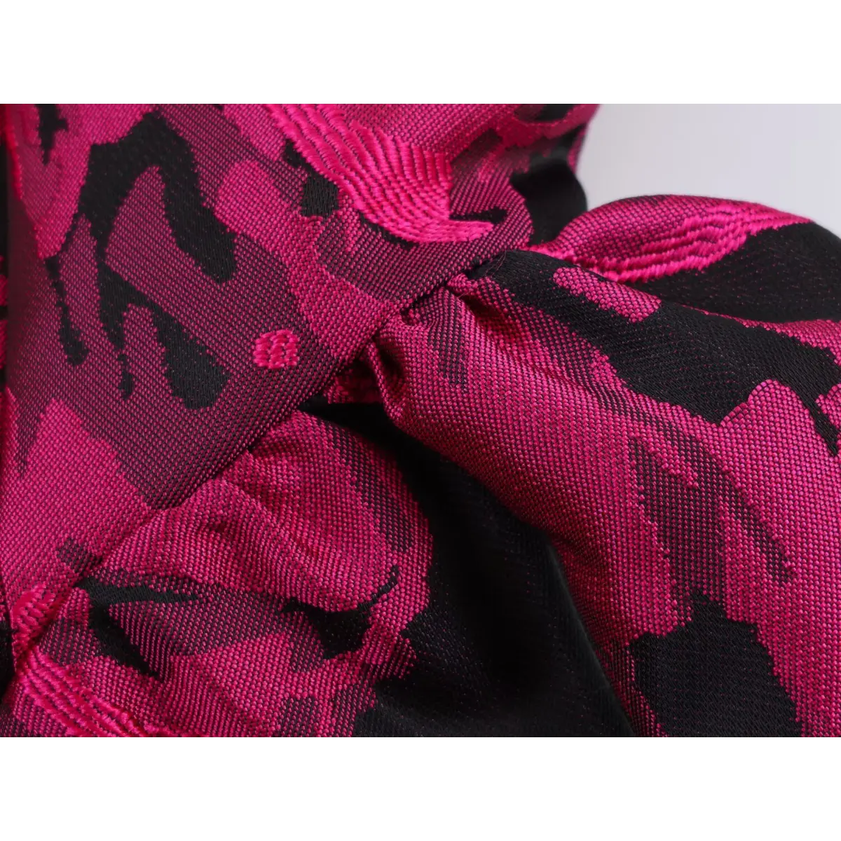 Close-up of the dress fabric texture, showing the raised floral jacquard weave