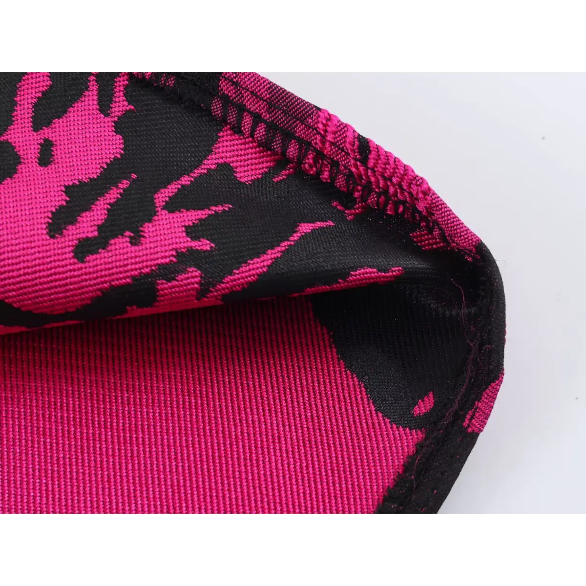 Close-up of the sleeveless shoulder area, showing the tailored armhole and jacquard pattern