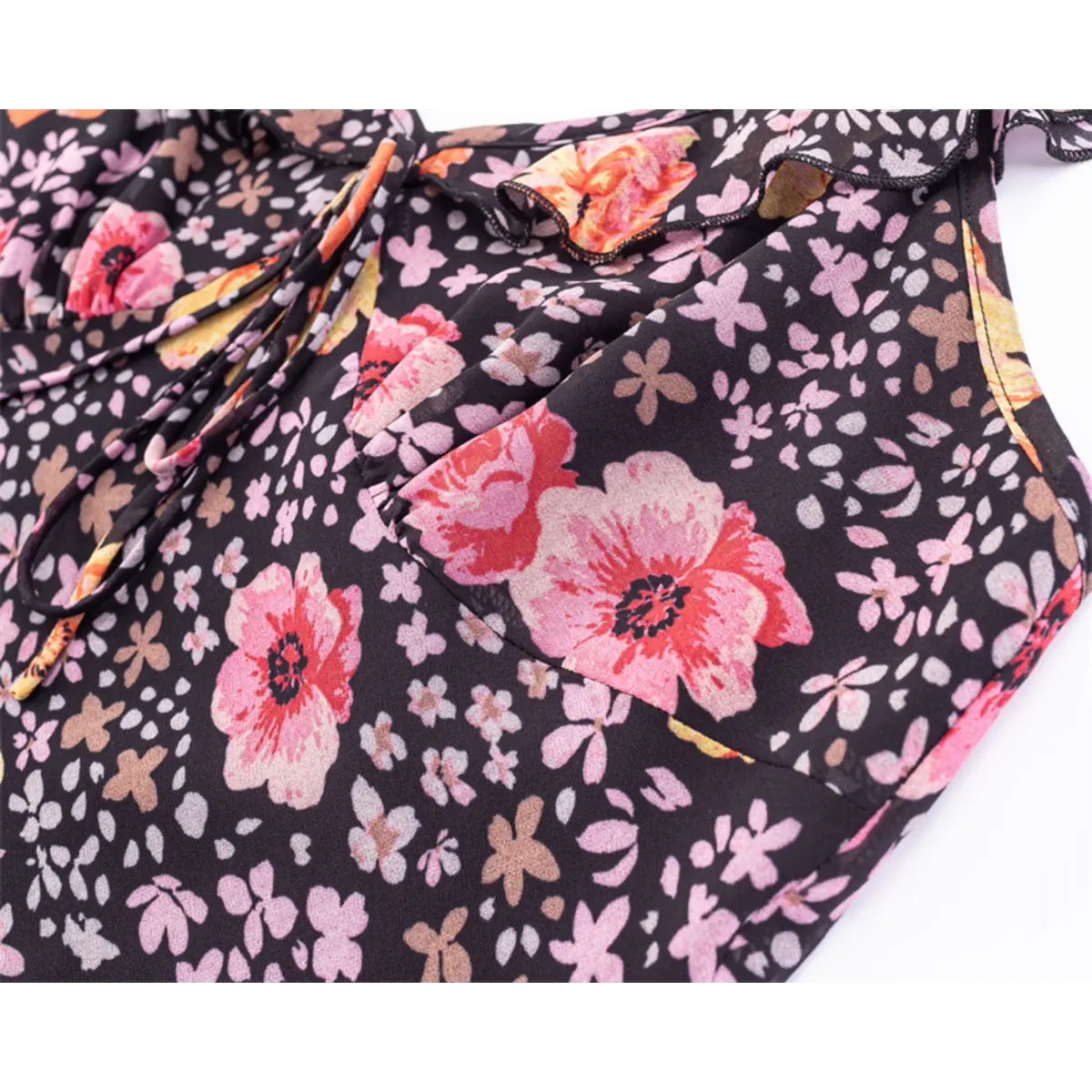 Close-up of the ditsy floral print on the black base, featuring large pink and orange flowers.