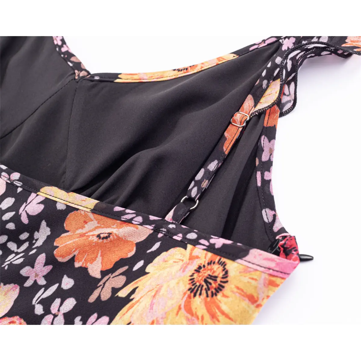 Close-up of the adjustable metal sliders on the spaghetti straps.