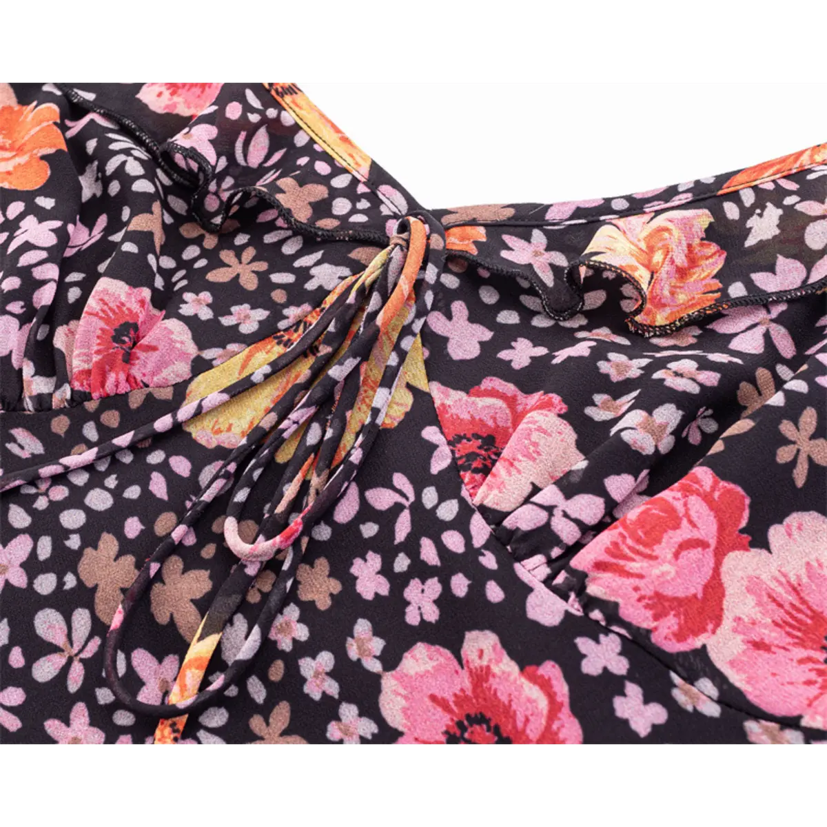 Close-up of the V-neckline with the front tie closure and ruffled trim.